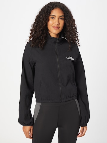 ADIDAS ORIGINALS - Chaqueta de entretiempo en negro: frente