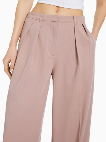 Bershka Loose fit Pleat-front trousers in Pink