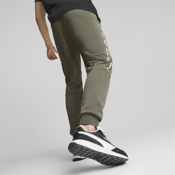 PUMA Tapered Sports trousers in Green