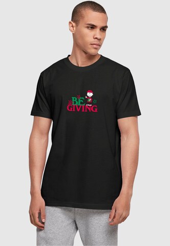 Merchcode T-Shirt 'Peanuts Be Giving' in Schwarz: predná strana