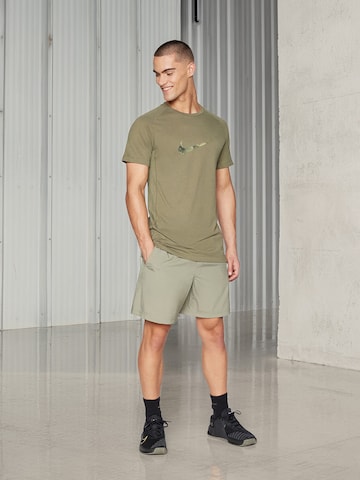 žalia NIKE Standartinis Kelnės