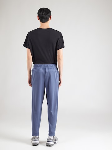 Effilé Pantalon de sport 'TOTALITY' NIKE en bleu