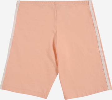 ADIDAS ORIGINALS Skinny Pants in Orange: front