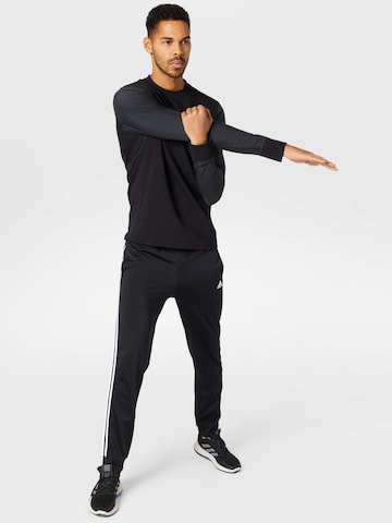 ADIDAS SPORTSWEAR Zwężany krój Spodnie sportowe 'Essentials' w kolorze czarny