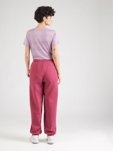 UNDER ARMOUR - Tapered Pantalón deportivo 'Icon Flc' en rojo