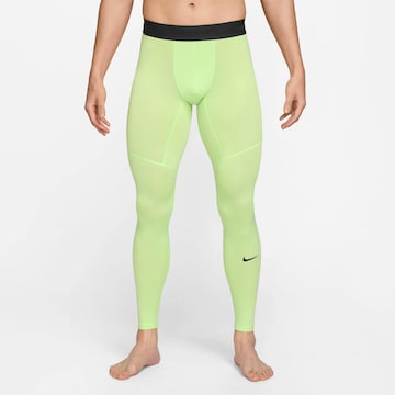 NIKE Skinny Workout Pants in Green: front