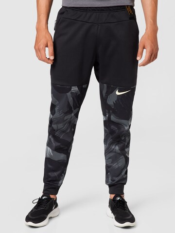 NIKE Tapered Workout Pants in Black: front