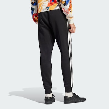 Tapered Pantaloni di ADIDAS ORIGINALS in nero