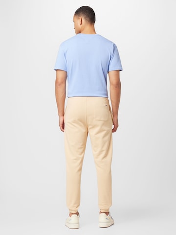Tommy Jeans Zwężany krój Spodnie w kolorze beżowy