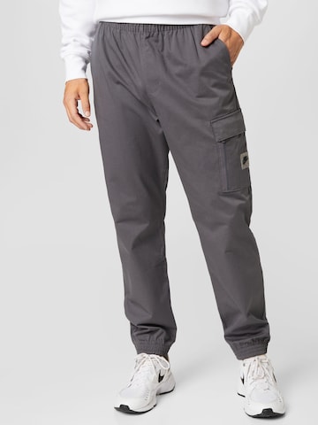 Nike Sportswear Tapered Trousers in Grey: front