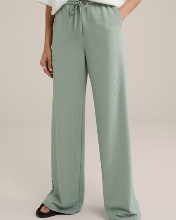 WE Fashion Loose fit Trousers in Green: front
