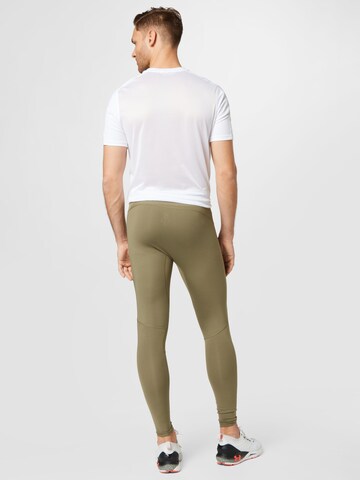 UNDER ARMOUR Skinny Sportbroek 'Rush' in Groen