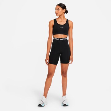 Skinny Pantaloni sport de la NIKE pe negru