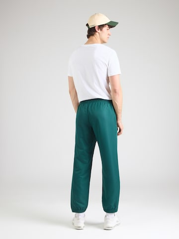 Sergio Tacchini Zwężany krój Spodnie sportowe 'Carson 021' w kolorze zielony