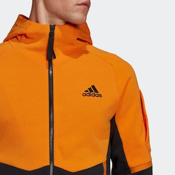 ADIDAS SPORTSWEAR Спортна жилетка с качулка в оранжево