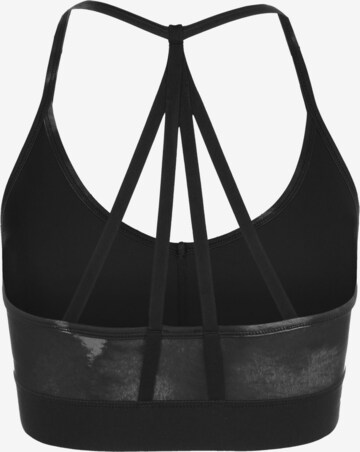 Bustino Reggiseno sportivo 'Risk Taker' di PUMA in nero