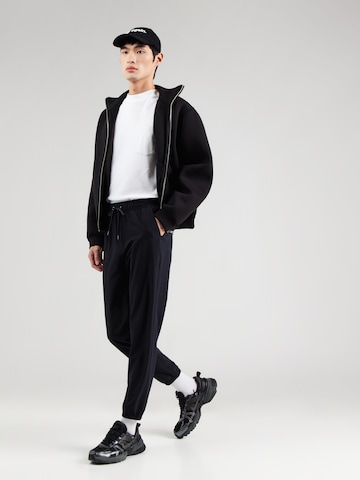 Tapered Pantaloni sportivi di SKECHERS in nero