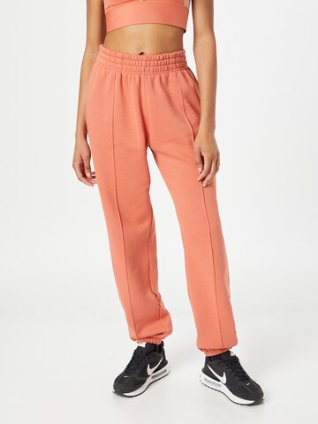 Nike Sportswear - Loosefit Calças em laranja: frente