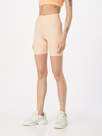 Champion Authentic Athletic Apparel - Skinny Pantalón deportivo en naranja: frente