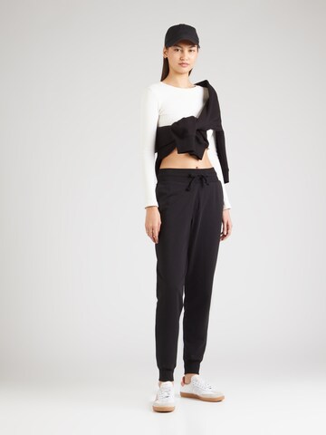 ABOUT YOU Tapered Trousers 'Teena' in Black