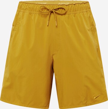NIKE Workout Pants 'Unlimited' in Yellow: front