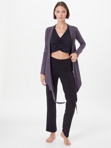 Evazați Pantaloni sport 'Flow' de la CURARE Yogawear pe negru