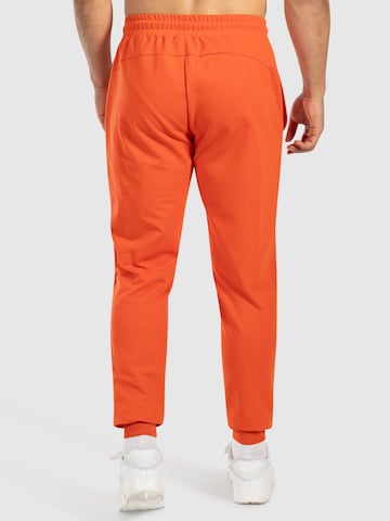 Effilé Pantalon de sport 'Nilo' Smilodox en orange