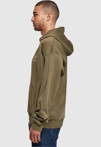 Merchcode Sweatshirt 'Cupid´s Assistant' in Groen