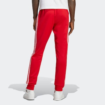 ADIDAS ORIGINALS Tapered Pants 'Adicolor Classics Sst' in Red