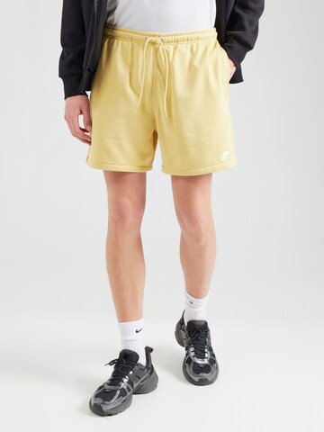 Nike Sportswear Loose fit Trousers 'CLUB' in Yellow: front