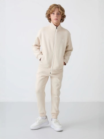 Tommy Life Trainingspak 'TOMMY Kinder Active Set' in Beige: voorkant