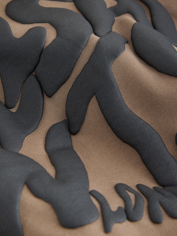 smALLSAINTS - Ropa para correr en marrón