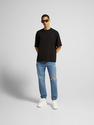 Tapered Jeans di Bershka in blu