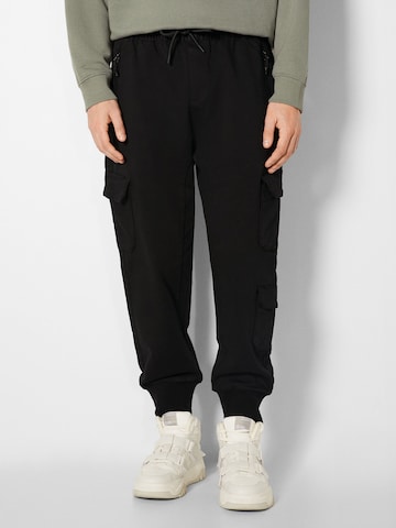 Bershka Tapered Chino Pants in Black: front