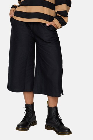 Turtledove London Regular Trousers in Black: front