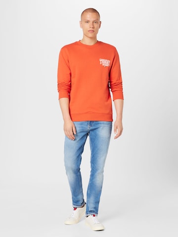 Bluză de molton de la Tommy Jeans pe portocaliu