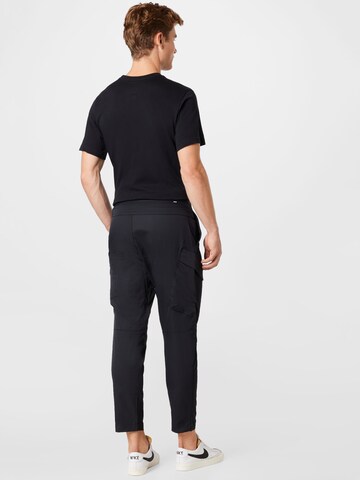 Nike Sportswear Slim fit Weatherproof pants in Black