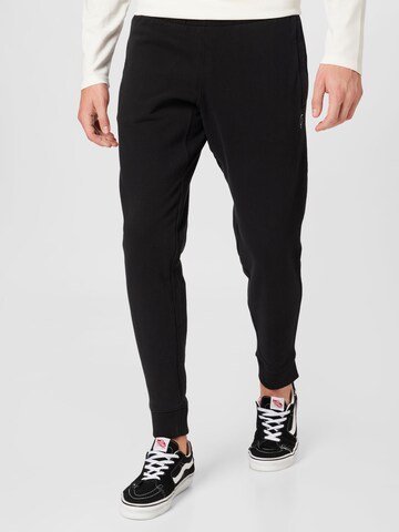 Superdry Tapered Trousers in Black: front