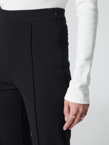 florence by mills exclusive for ABOUT YOU Flared Pants 'Spruce' in Black