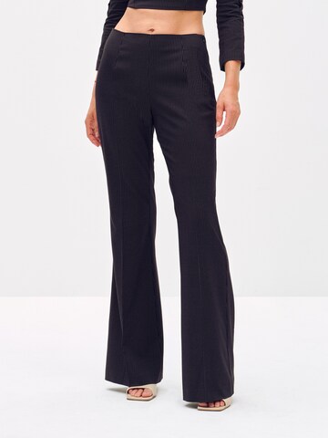 ABOUT YOU x Toni Garrn Flared Pleated Pants 'Elonie' in Black: front