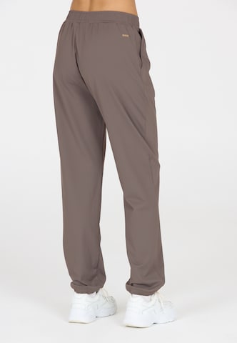 Athlecia Regular Sports trousers in Brown