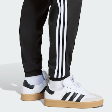 ADIDAS ORIGINALS Дънки Tapered Leg Панталон 'SST' в черно