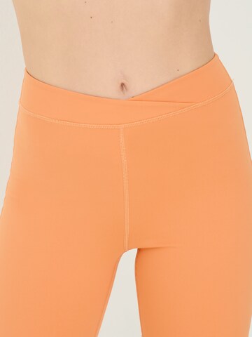 ABOUT YOU x Sofia Tsakiridou Skinny Shorts 'Anouk' in Orange