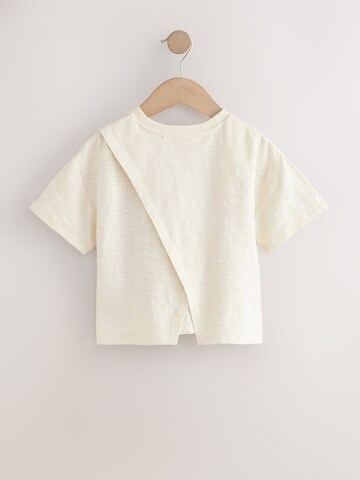 Tricou de la Next pe bej