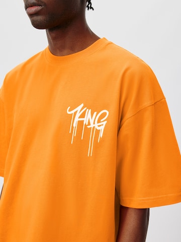 ABOUT YOU x Kingsley Coman Koszulka 'Aaron' w kolorze pomarańczowy