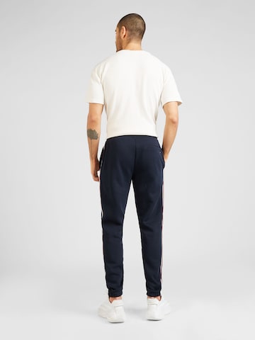 TOMMY HILFIGER - Tapered Pantalón 'GLOBAL STRIPE' en azul