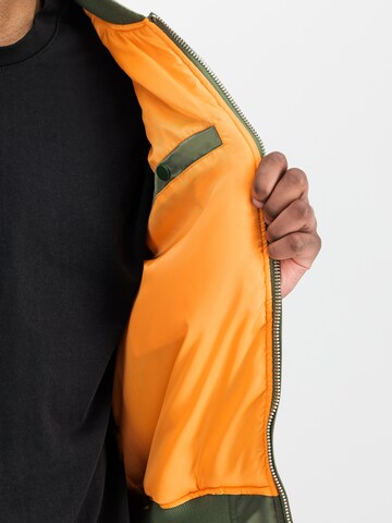 ALPHA INDUSTRIES Between-Season Jacket 'MA-1 Black Devils' in Green: front