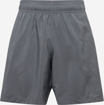 Regular Pantalon de sport UNDER ARMOUR en gris : devant