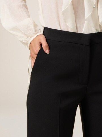 oltre - Acampanado Pantalón en negro