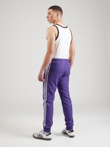ADIDAS PERFORMANCE Zwężany krój Spodnie sportowe w kolorze fioletowy